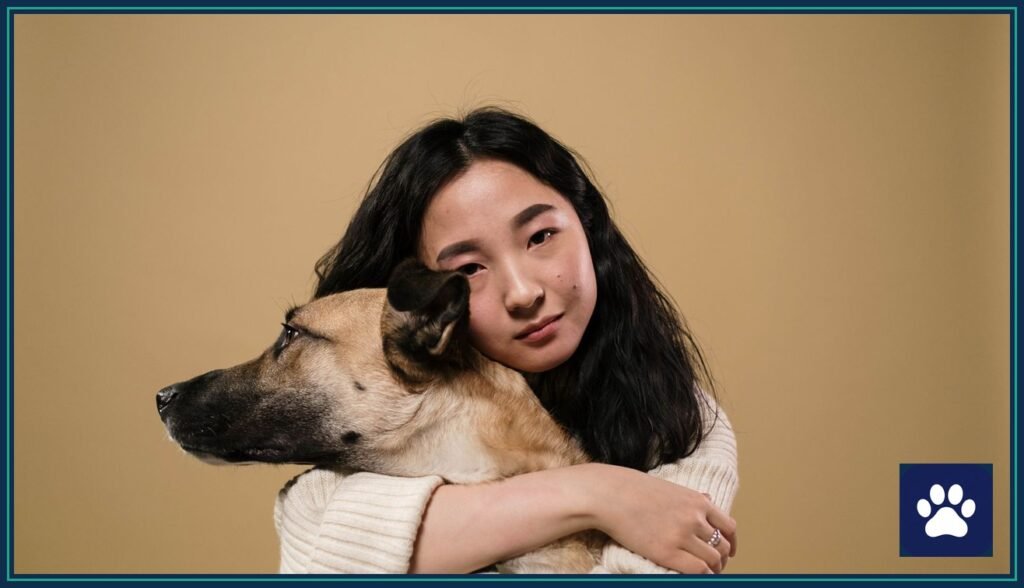 Dog owner hugging a new rescue dog — deciding when to get a new dog after one dies